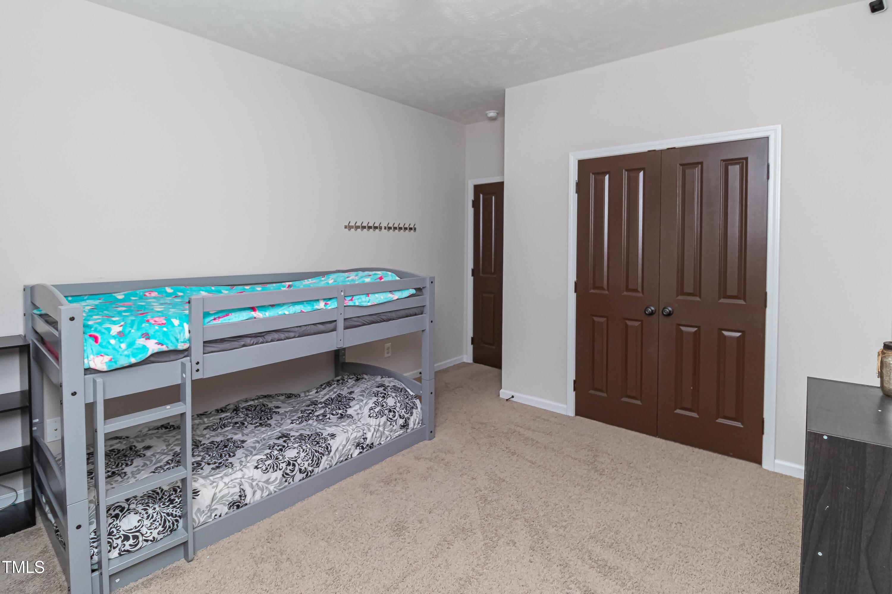 1852 Alderman Mill Road Dunn, NC 28334 - Photo 17 of 36 a bed room with a bed and a television