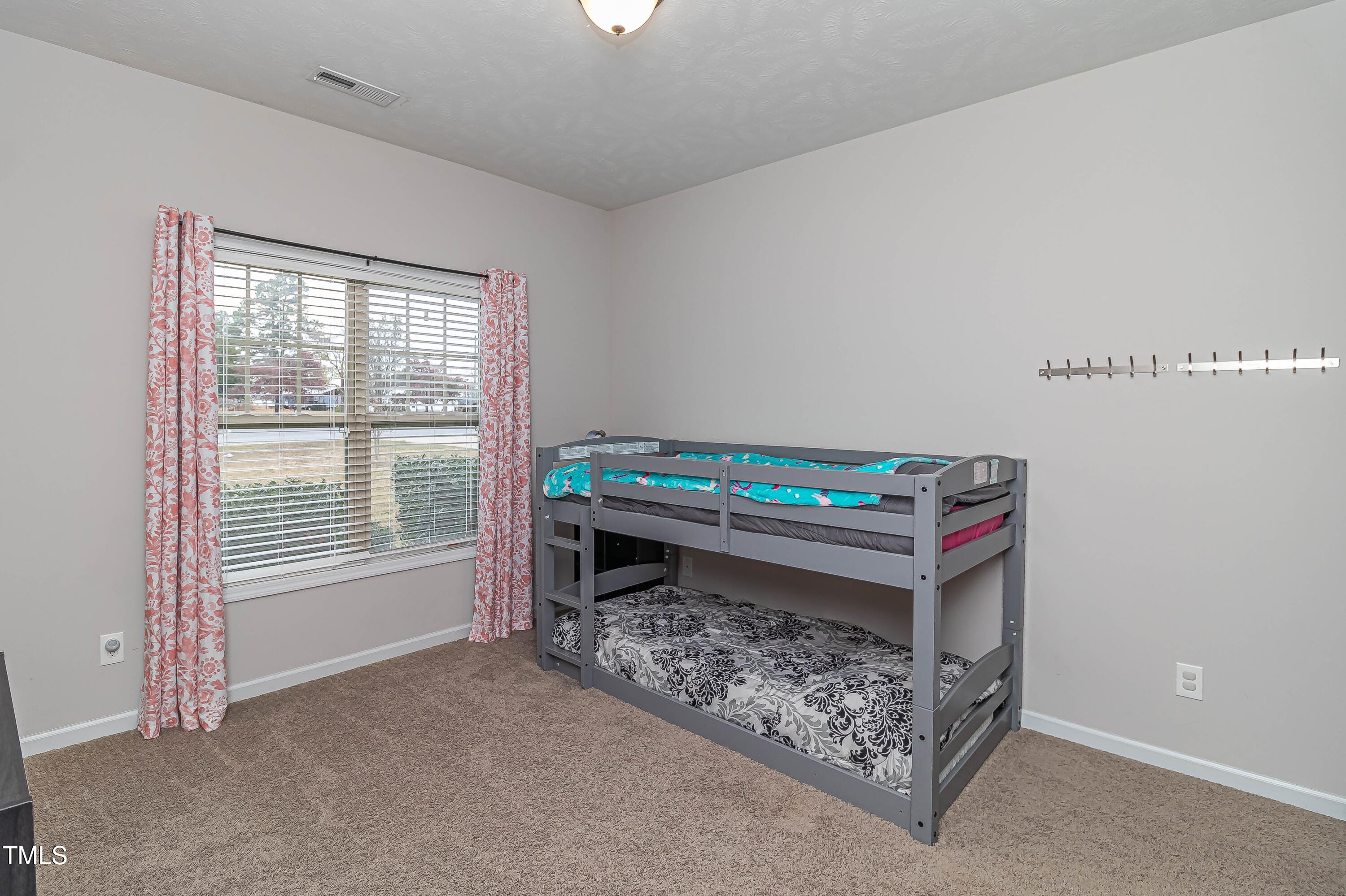 1852 Alderman Mill Road Dunn, NC 28334 - Photo 18 of 36 a view of an empty room with a fireplace and a window