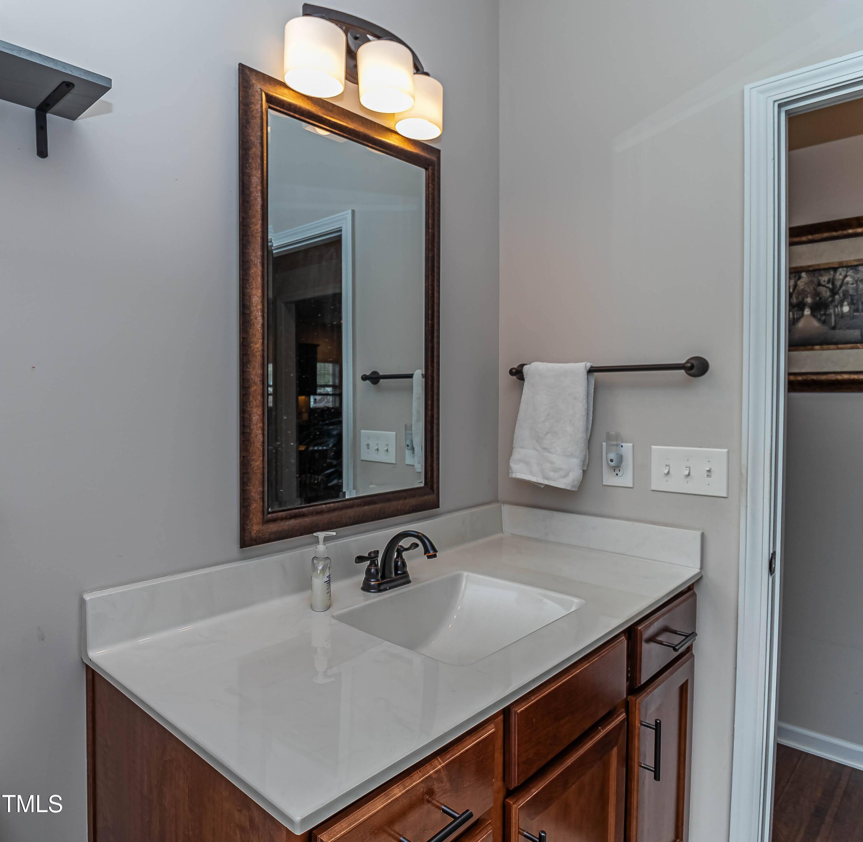 1852 Alderman Mill Road Dunn, NC 28334 - Photo 21 of 36 a bathroom with a sink vanity and a mirror