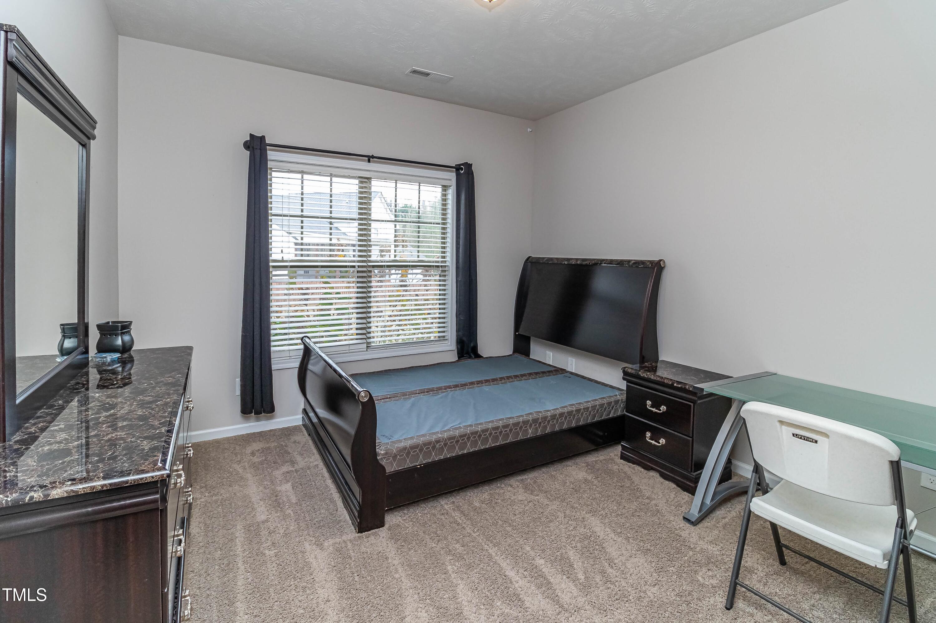 1852 Alderman Mill Road Dunn, NC 28334 - Photo 22 of 36 a living room with furniture and a window