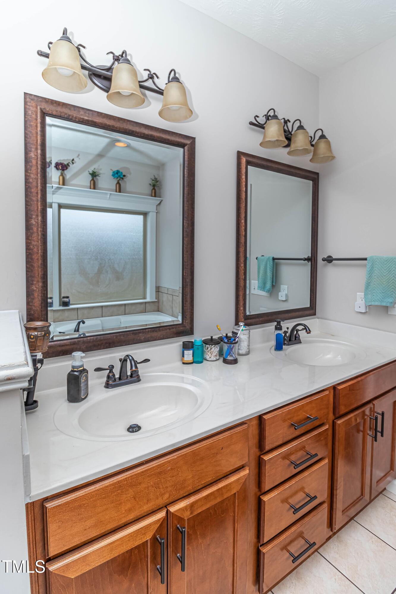 1852 Alderman Mill Road Dunn, NC 28334 - Photo 30 of 36 a bathroom with a sink and a mirror