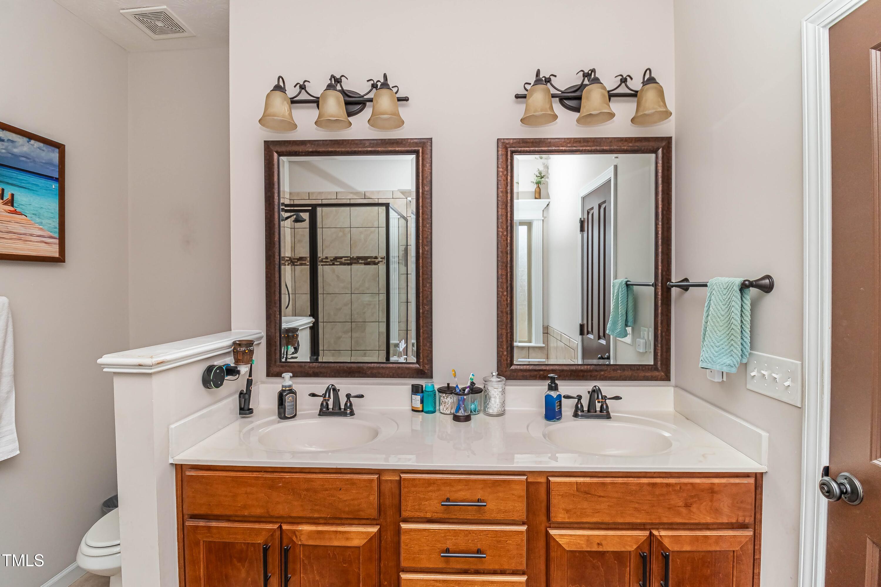1852 Alderman Mill Road Dunn, NC 28334 - Photo 31 of 36 a bathroom with a sink and a mirror