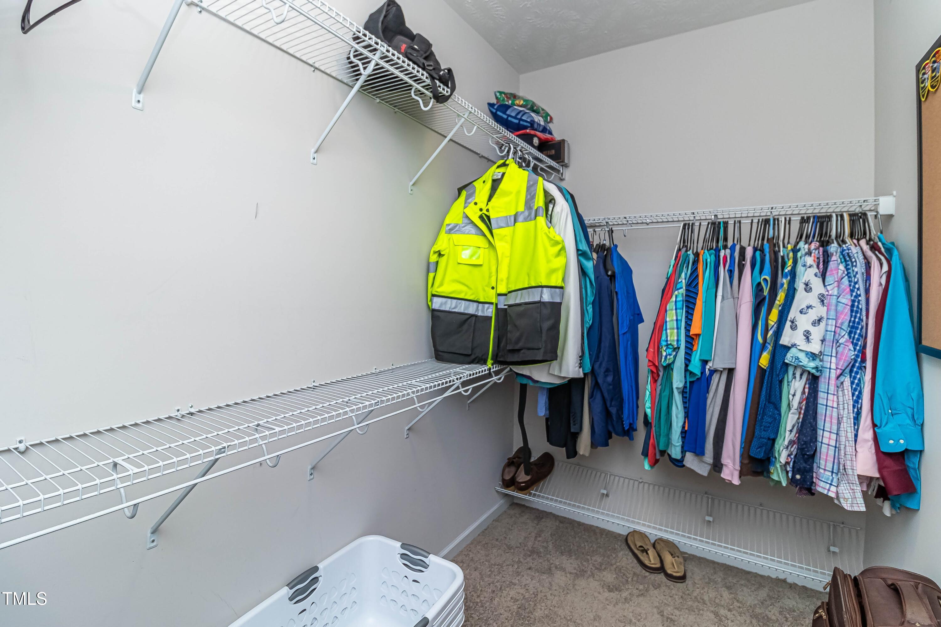 1852 Alderman Mill Road Dunn, NC 28334 - Photo 33 of 36 a view of walk in closet with clothes and shoes