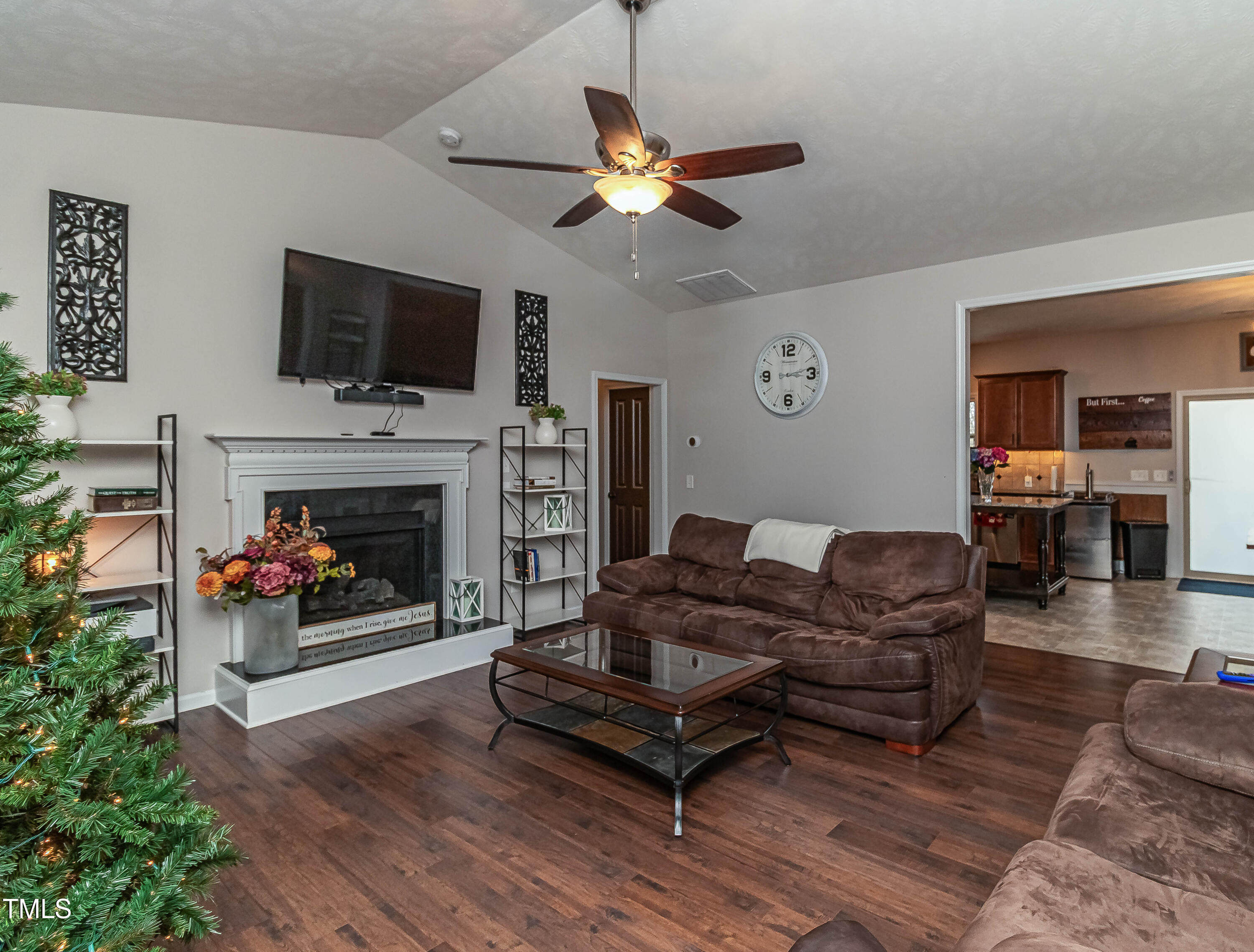 1852 Alderman Mill Road Dunn, NC 28334 - Photo 5 of 36 a living room with furniture a flat screen tv and a fireplace