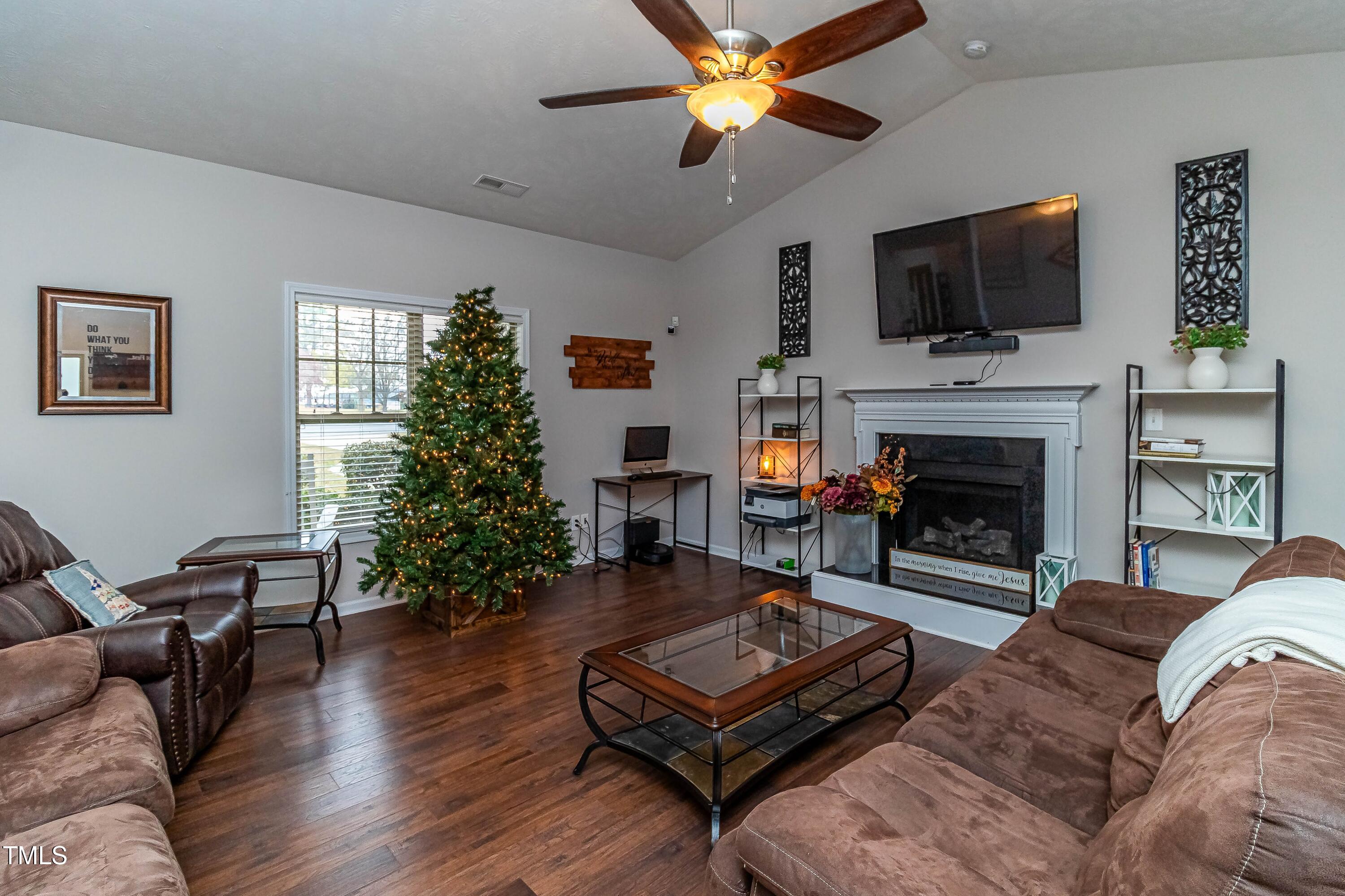 1852 Alderman Mill Road Dunn, NC 28334 - Photo 6 of 36 a living room with furniture a flat screen tv and a fireplace