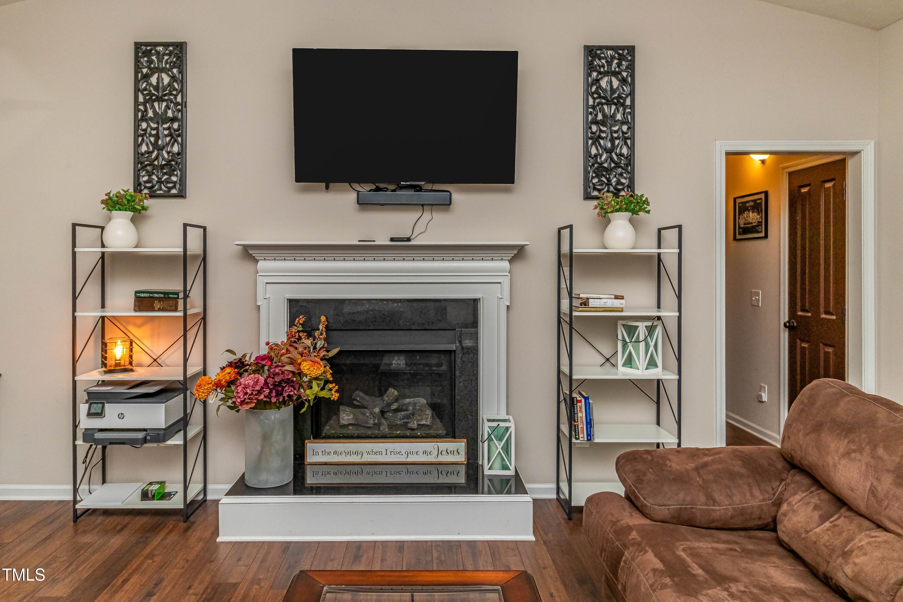 1852 Alderman Mill Road Dunn, NC 28334 - Photo 7 of 36 a living room with furniture a flat screen tv and a fireplace