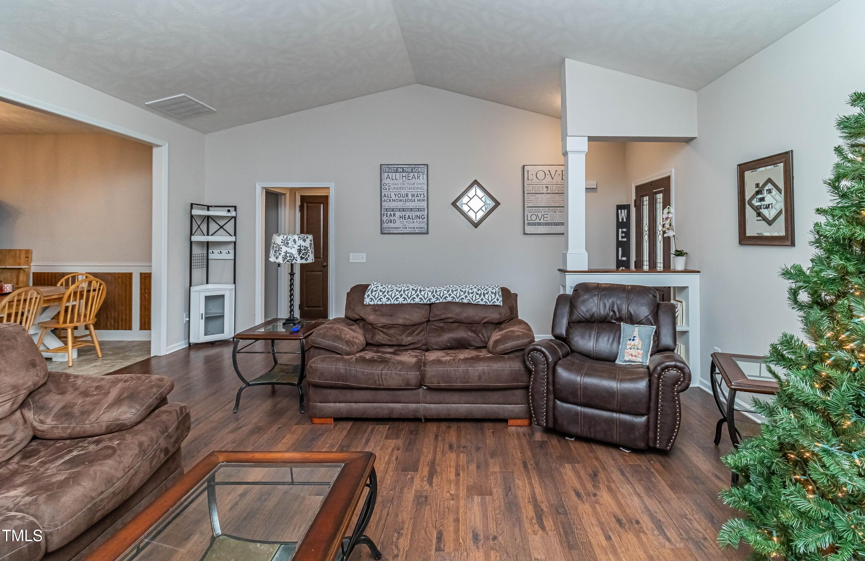 1852 Alderman Mill Road Dunn, NC 28334 - Photo 8 of 36 a living room with furniture fireplace and wooden floor