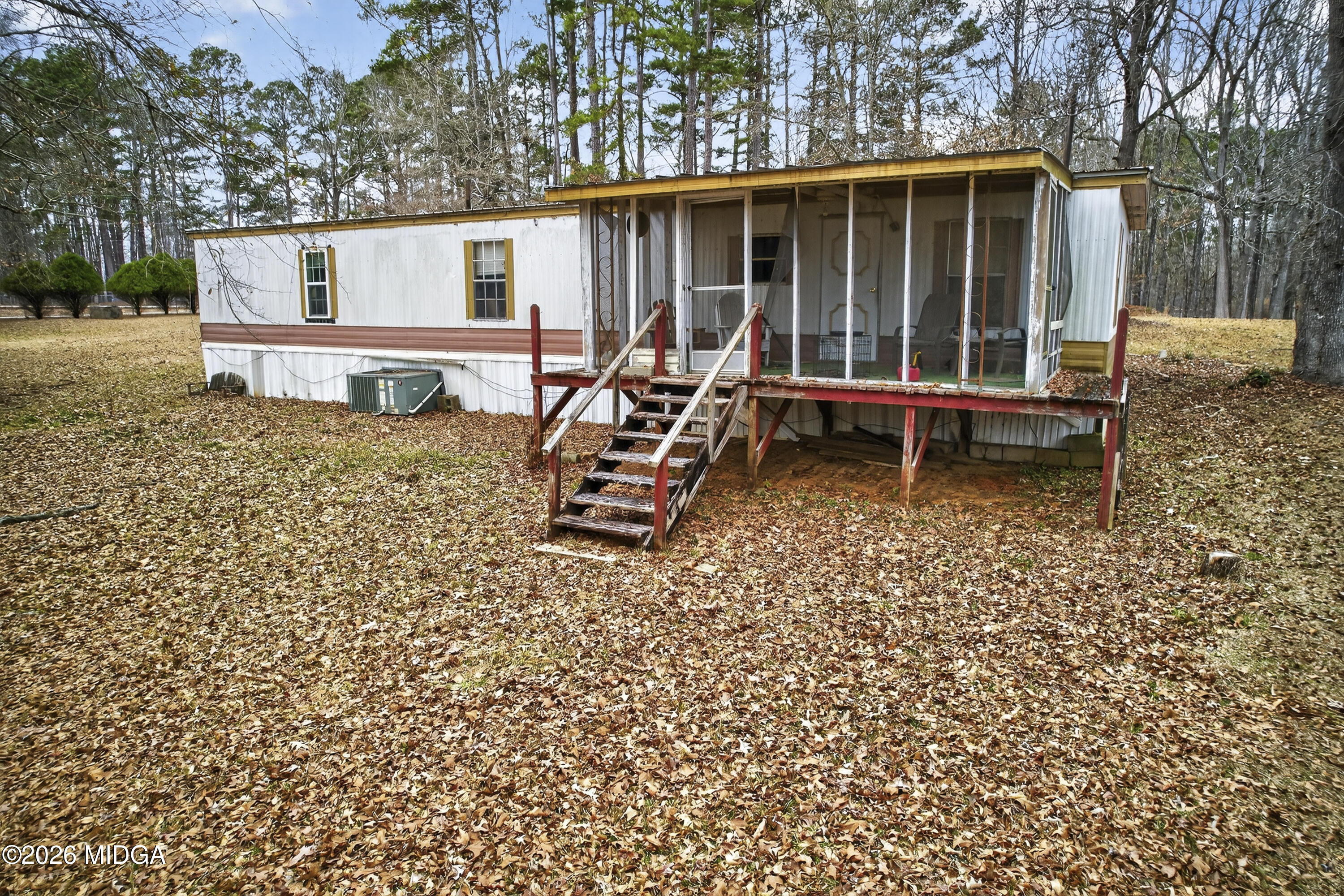 109 Cold Branch Lane Eatonton, GA 31024 - Photo 17 of 35 a view of a wooden bench sitting in backyard of a house
