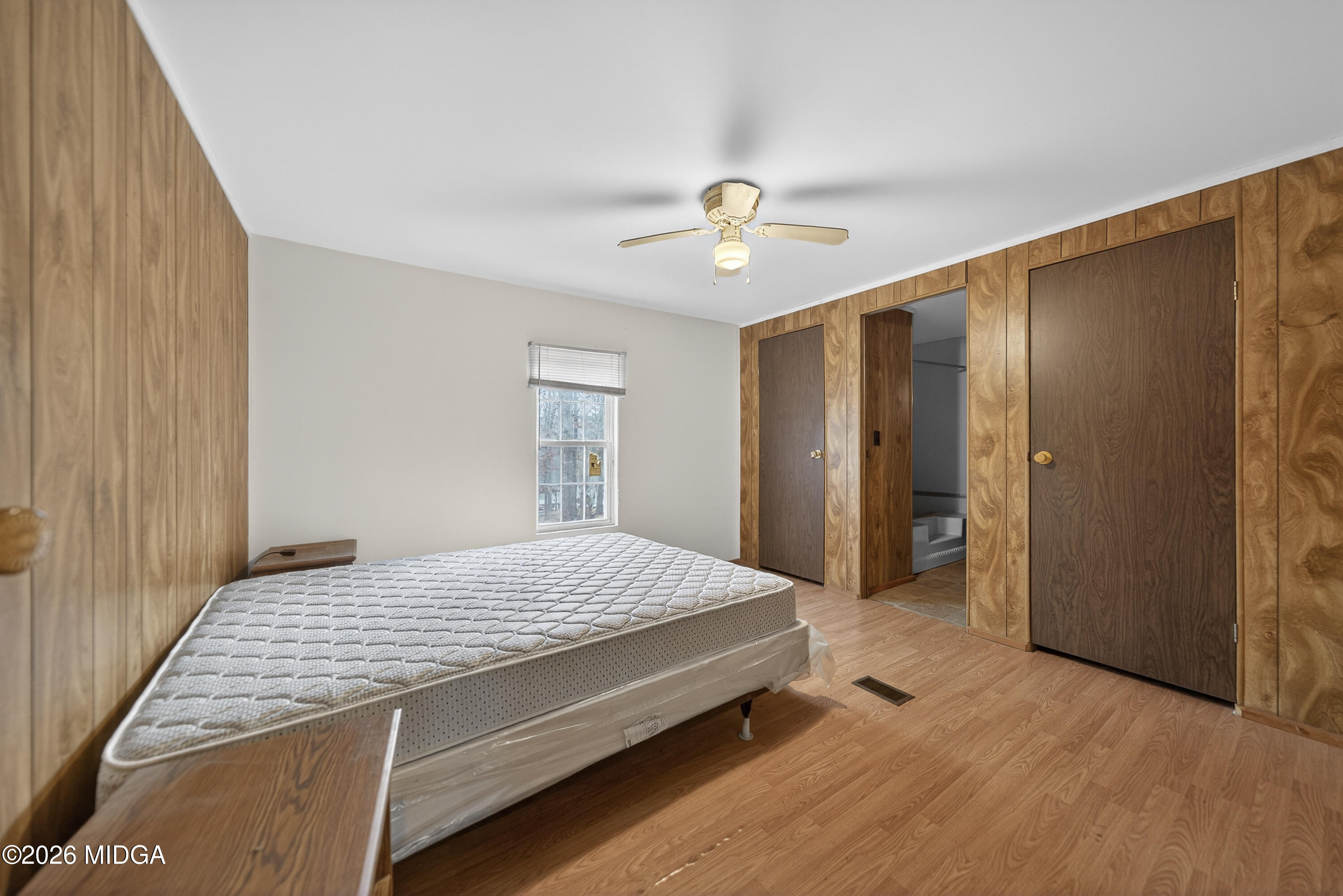 109 Cold Branch Lane Eatonton, GA 31024 - Photo 30 of 35 a spacious bedroom with a bed and a chandelier