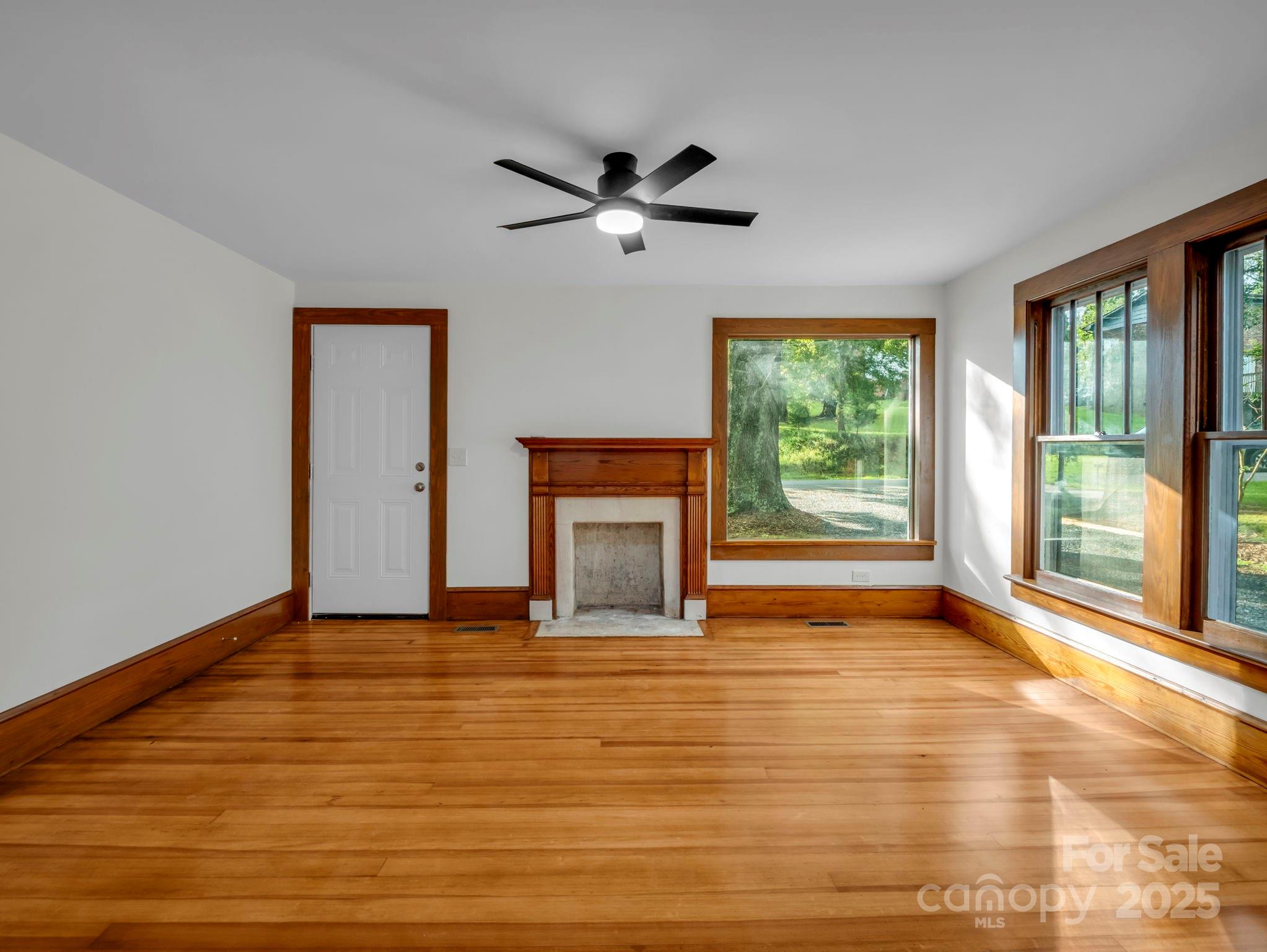 339 Flack Road Forest City, NC 28043 - Photo 17 of 32 a view of an empty room with window and wooden floor