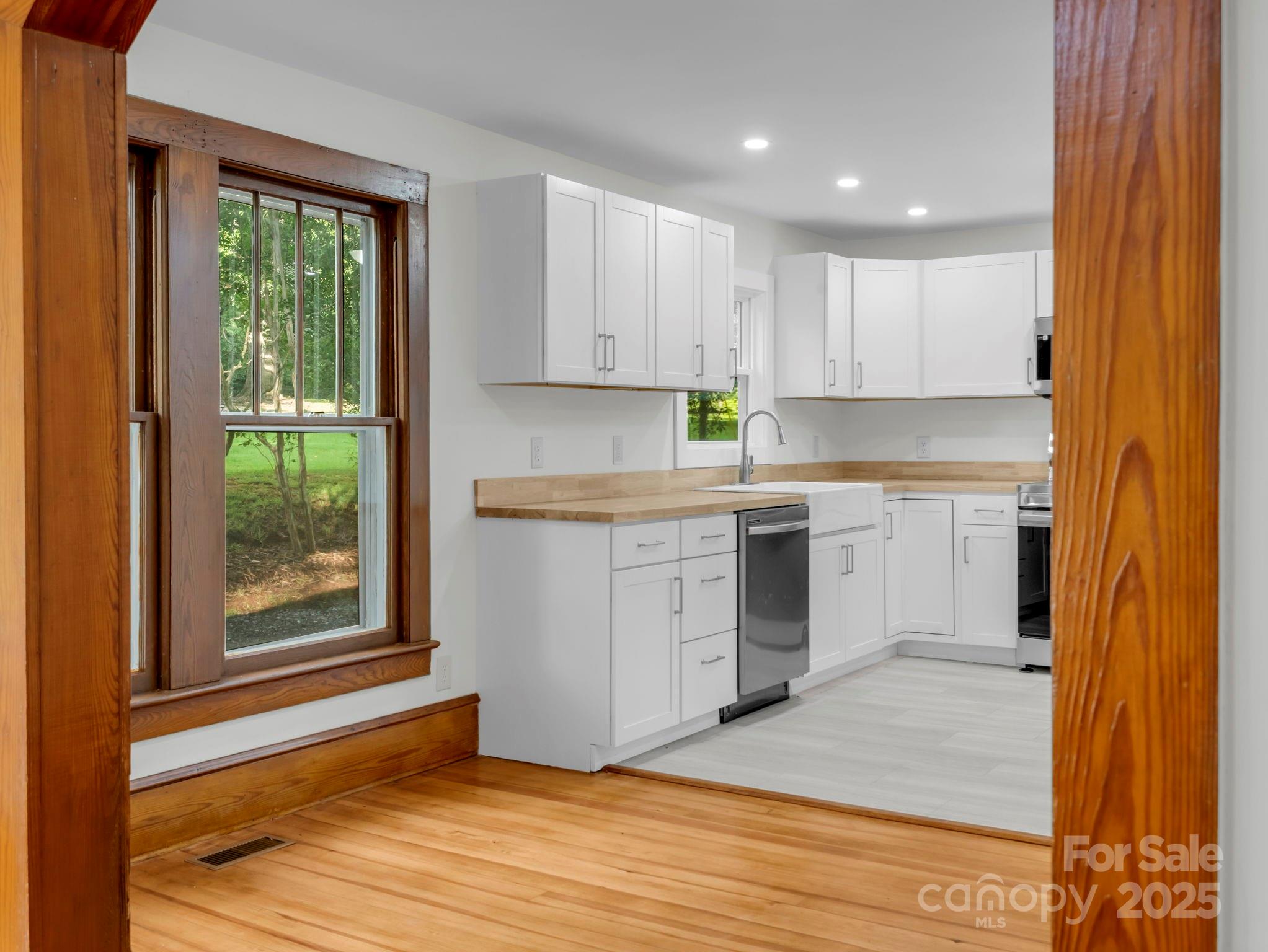 339 Flack Road Forest City, NC 28043 - Photo 20 of 32 a kitchen with a stove a sink and a window