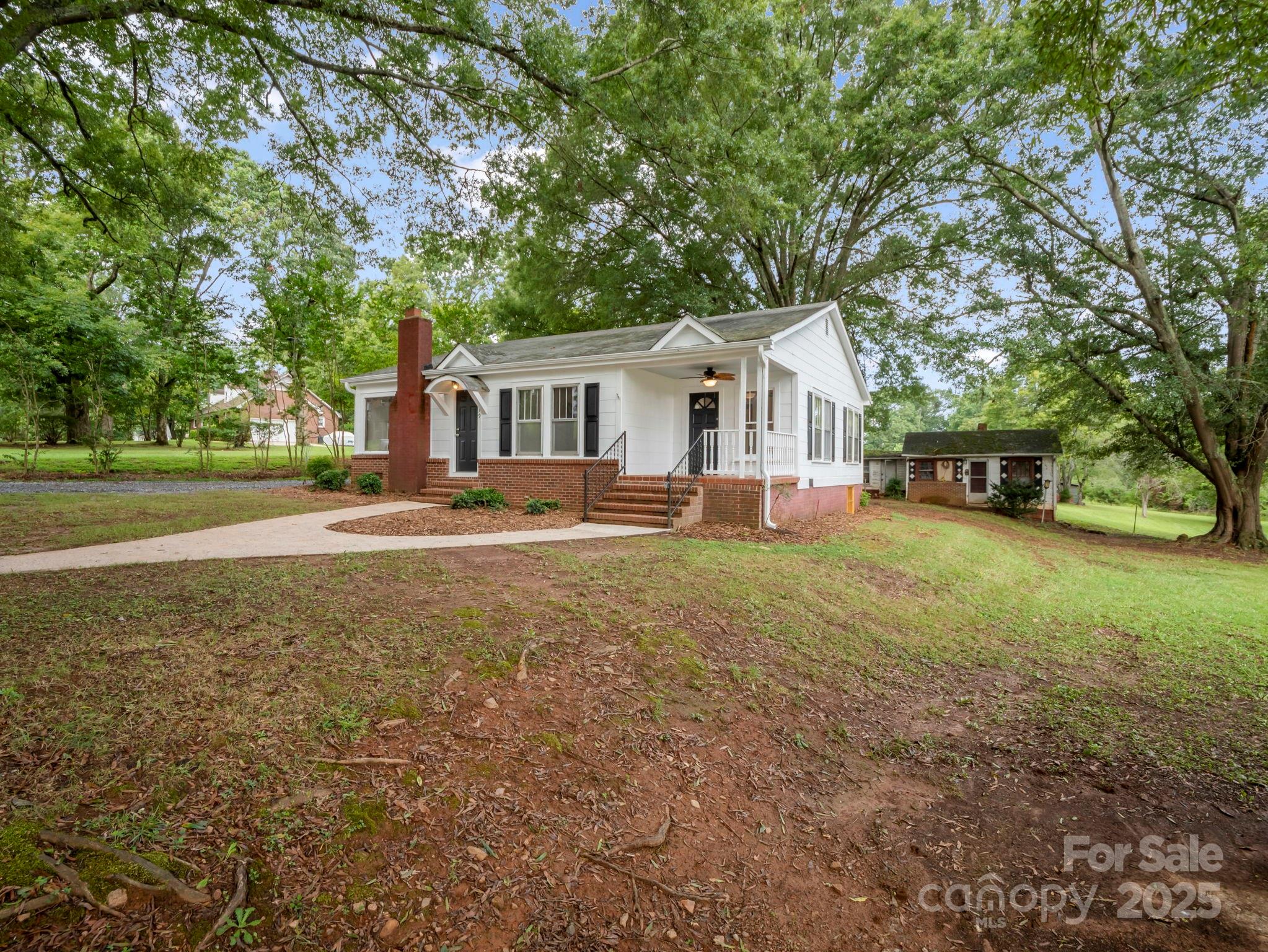 339 Flack Road Forest City, NC 28043 - Photo 3 of 32 a front view of a house with a yard and trees
