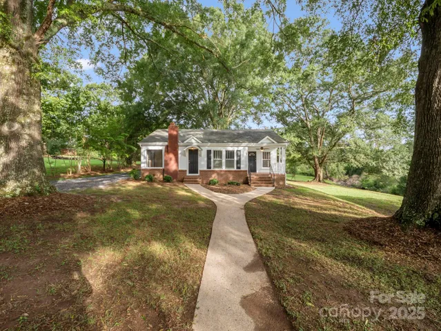 a view of house with yard