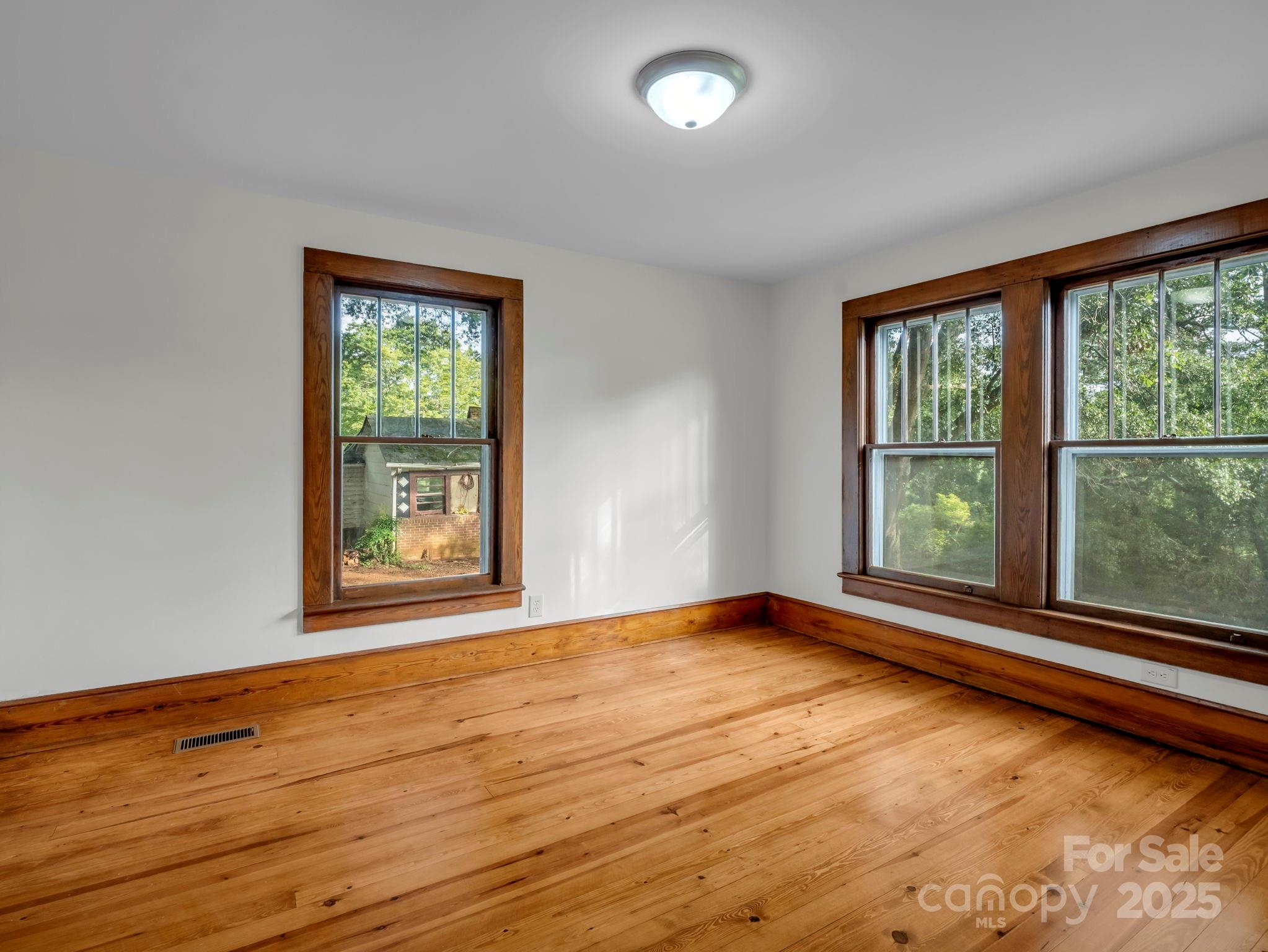 339 Flack Road Forest City, NC 28043 - Photo 10 of 32 a view of an empty room with wooden floor and a window