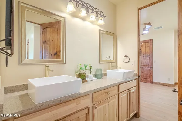 a spacious bathroom with a tub sink and mirror