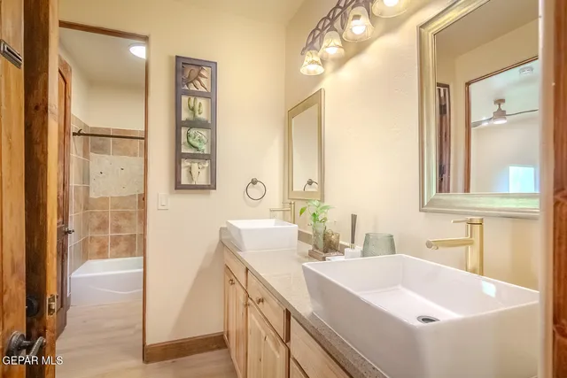 a bathroom with a granite countertop sink mirror and