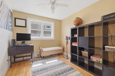 a view of a workspace with furniture and a window