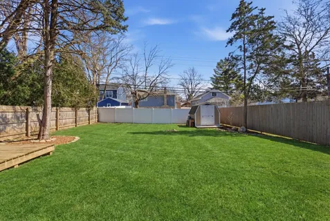 a backyard of a house with table and chairs