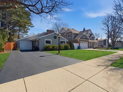 a front view of house with yard and green space