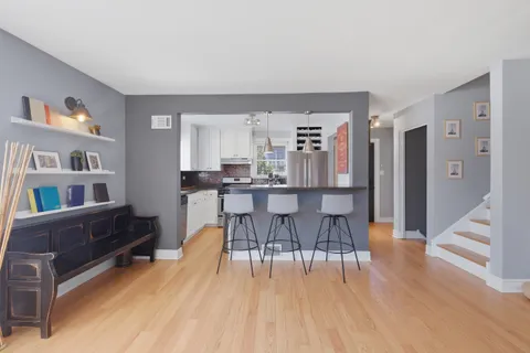 a dining room with furniture and wooden floor