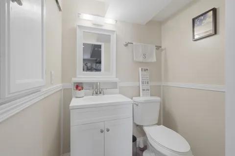 a bathroom with a toilet sink and mirror