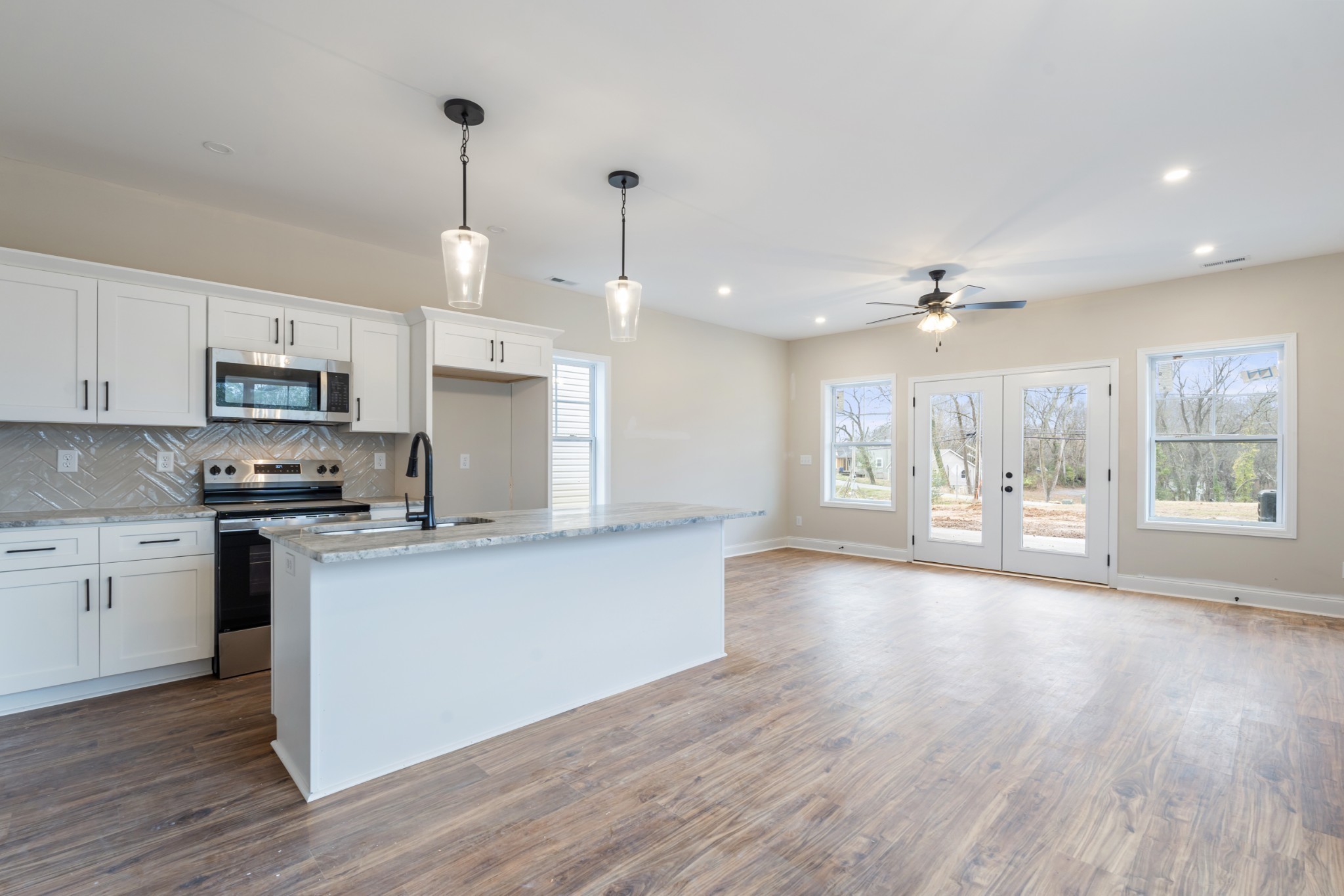 83 Charlotte Road Clarksville, TN 37040 - Photo 6 of 24 a kitchen with stainless steel appliances granite countertop a stove top oven a sink dishwasher and a refrigerator with wooden floor