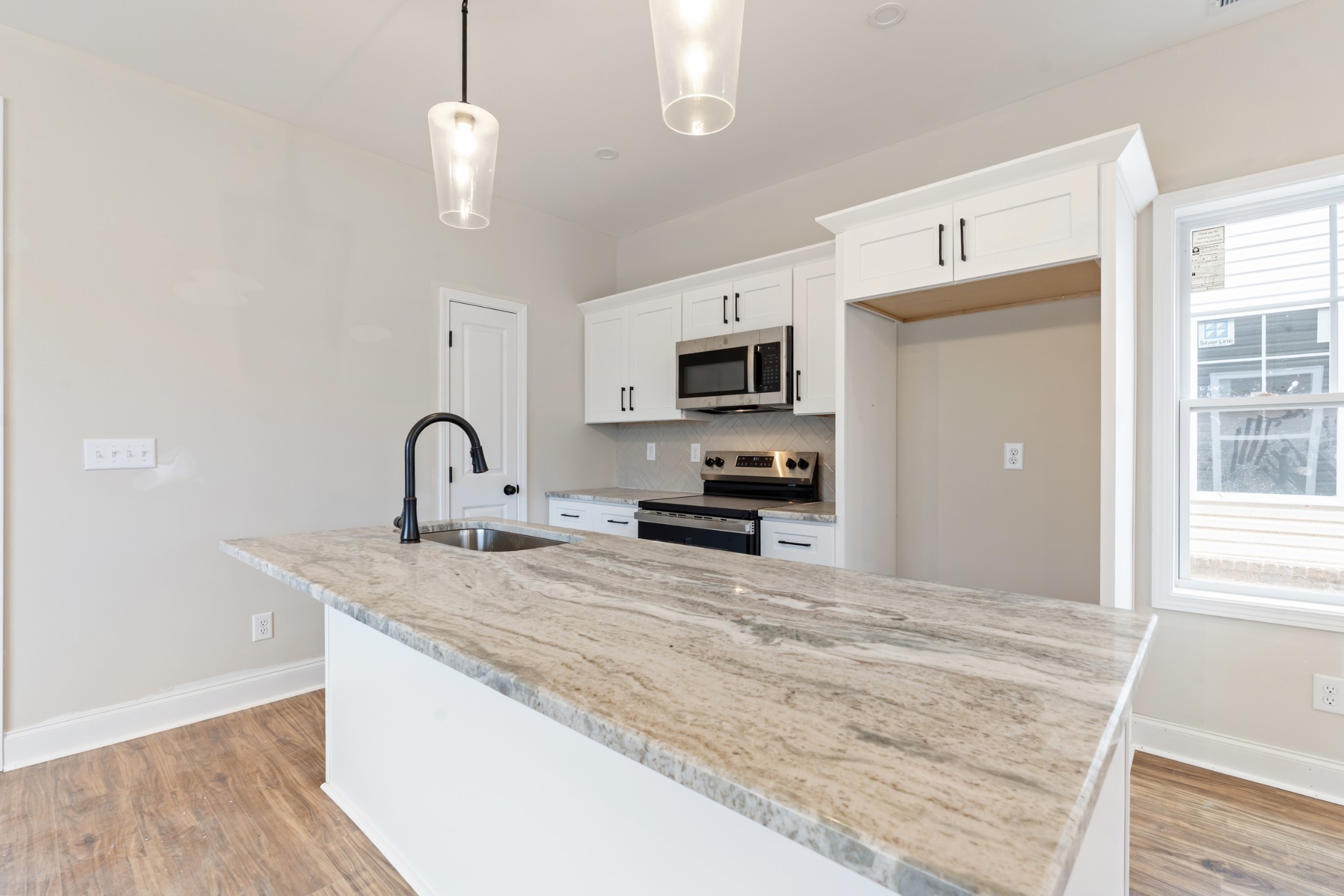 83 Charlotte Road Clarksville, TN 37040 - Photo 7 of 24 a large kitchen with kitchen island a sink stainless steel appliances and cabinets