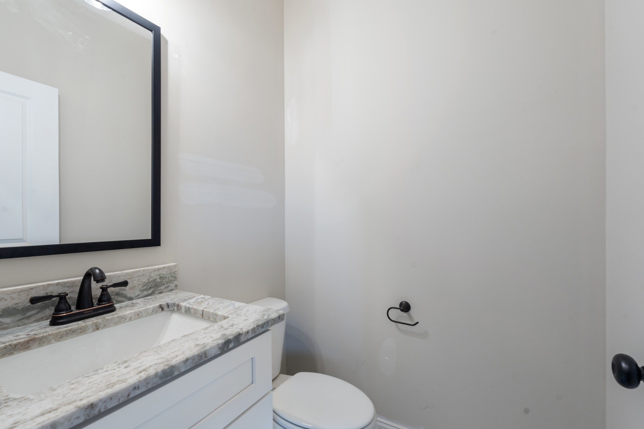 83 Charlotte Road Clarksville, TN 37040 - Photo 10 of 24 a bathroom with a granite countertop toilet sink and mirror