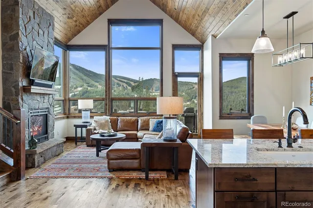 a living room with furniture fireplace and a large window