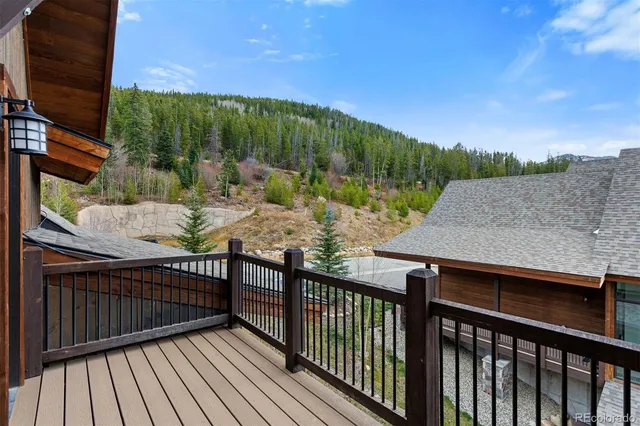 a view of a balcony with wooden floor and fence