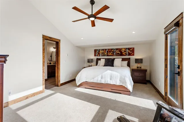 a bedroom with a bed and a ceiling fan