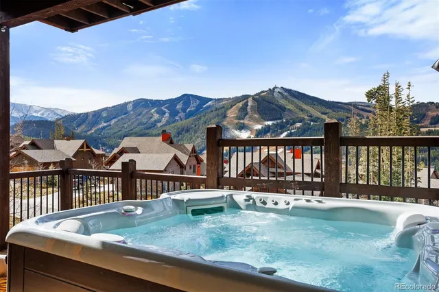 a aerial view of a house with a big yard and large tree