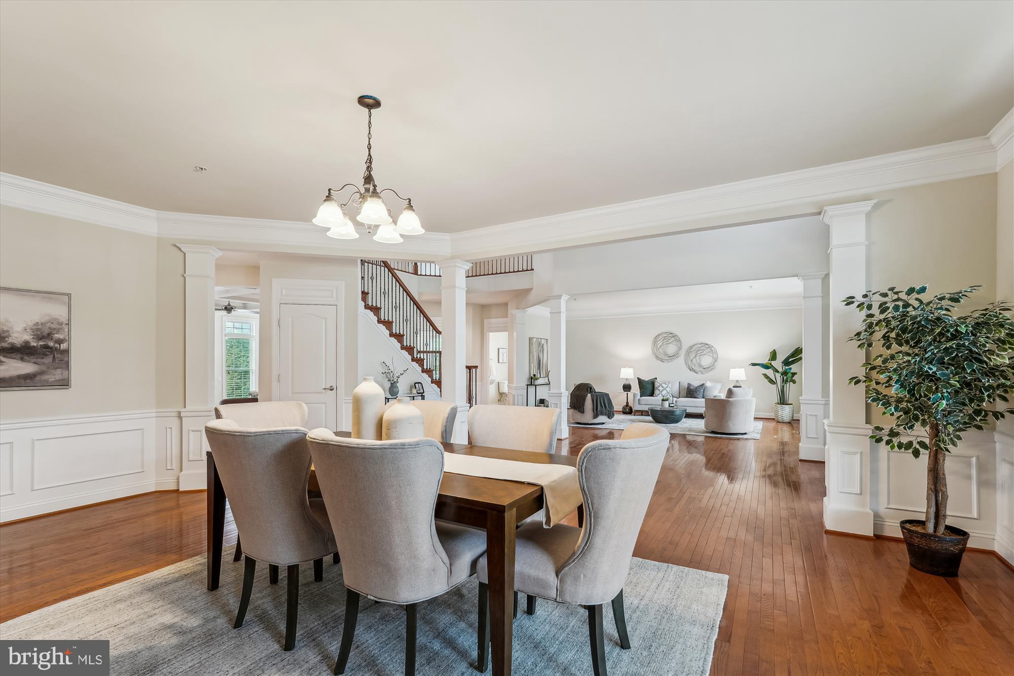 4806 Fair Hill Road Olney, MD 20832 - Photo 16 of 77 a dining room with wooden floor a chandelier a wooden table and chairs