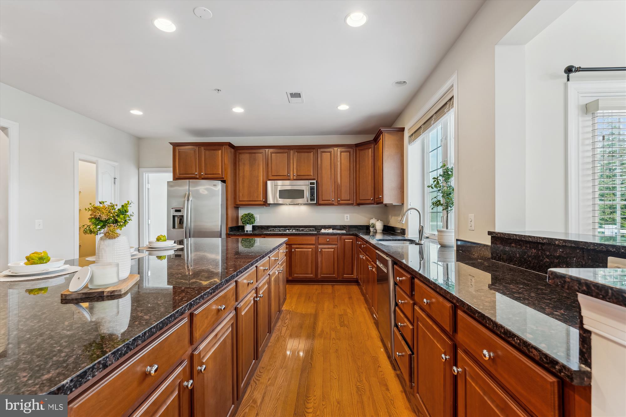 4806 Fair Hill Road Olney, MD 20832 - Photo 23 of 77 a large kitchen with kitchen island lots of counter space a sink a stove and a refrigerator