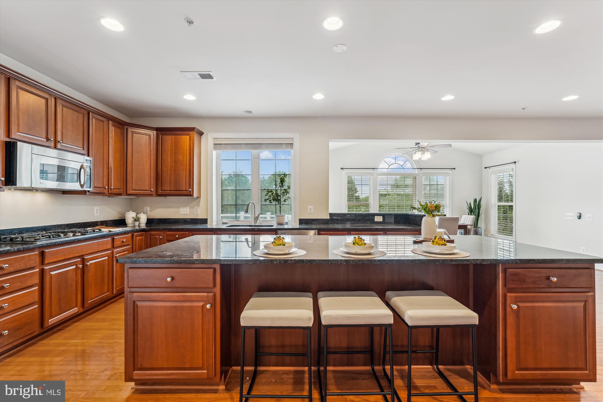 4806 Fair Hill Road Olney, MD 20832 - Photo 26 of 77 a kitchen with stainless steel appliances granite countertop wooden cabinets and a stove top oven