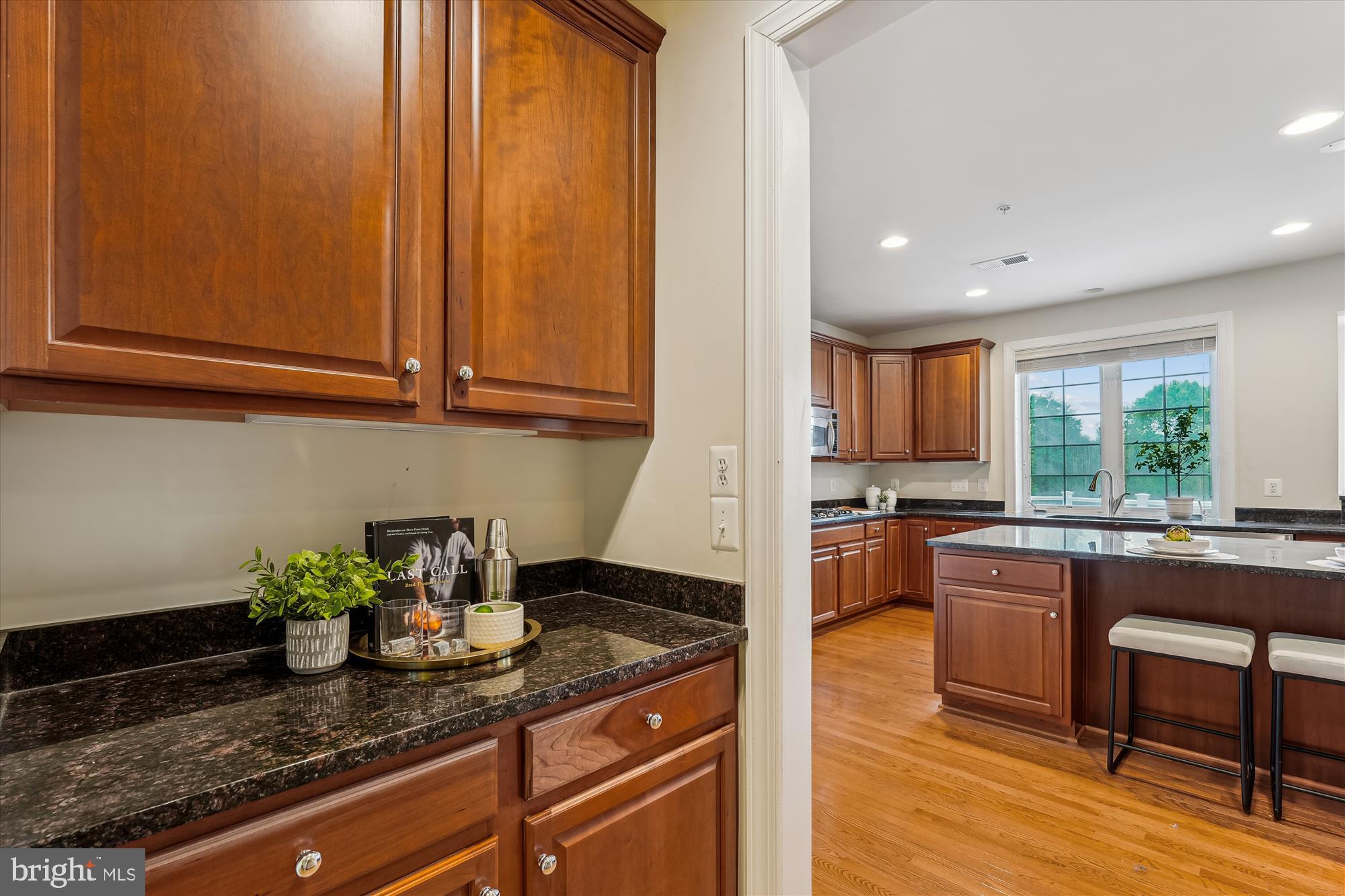 4806 Fair Hill Road Olney, MD 20832 - Photo 27 of 77 a kitchen with stainless steel appliances granite countertop wooden cabinets a stove a sink and a window