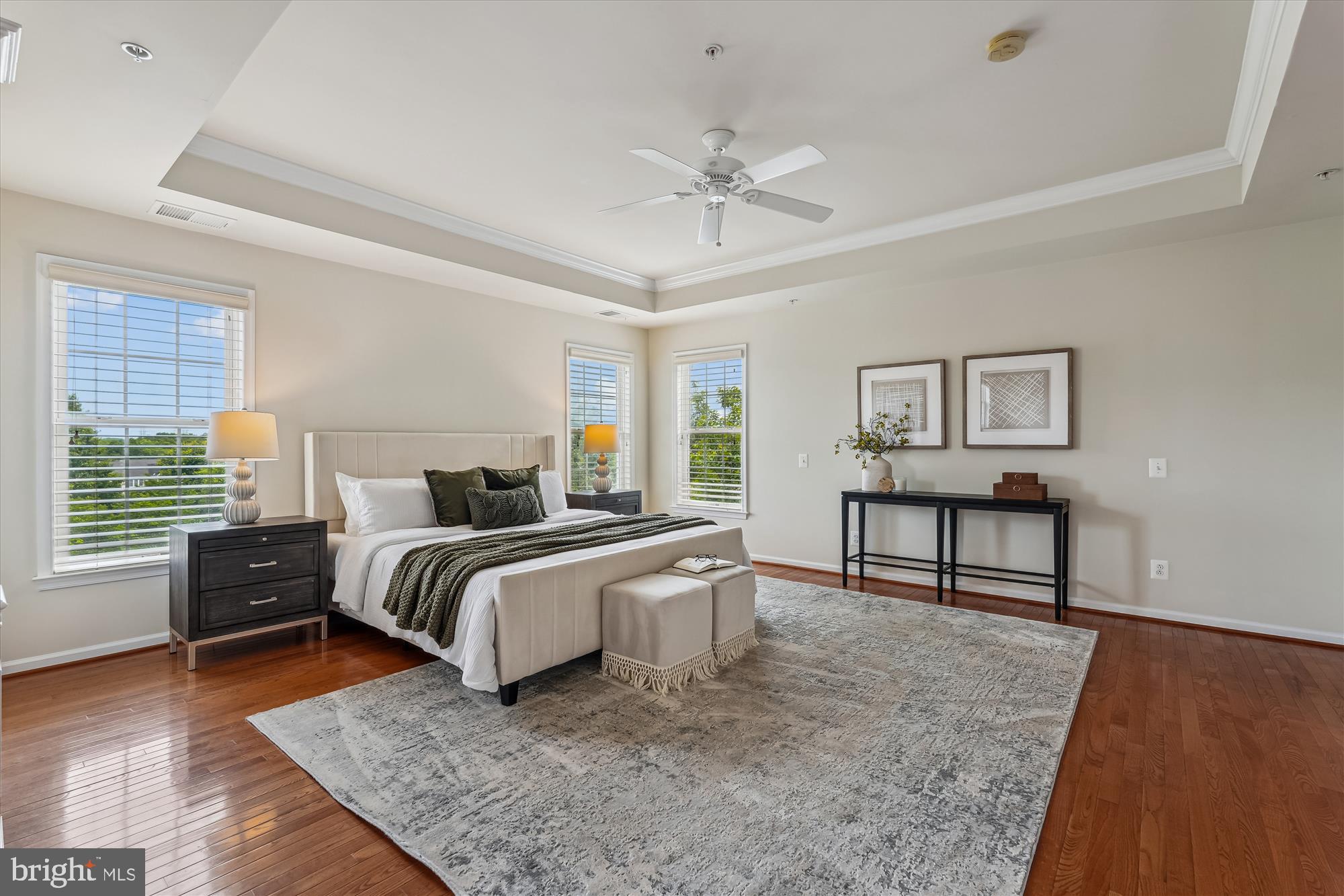 4806 Fair Hill Road Olney, MD 20832 - Photo 43 of 77 a spacious bedroom with a bed a dresser and wooden floor