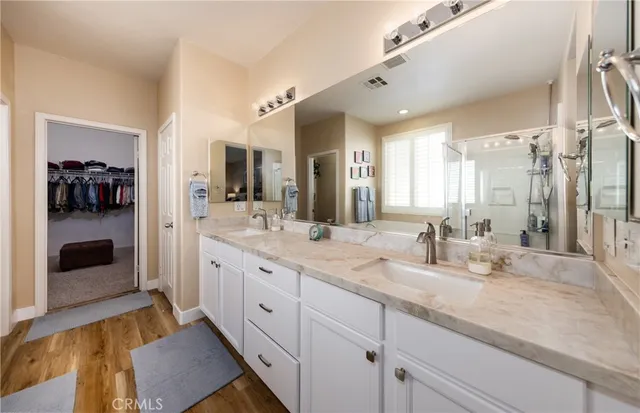 a spacious bathroom with a granite countertop sink mirror and shower