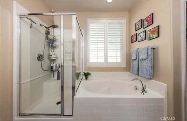 a bathroom with a tub and shower