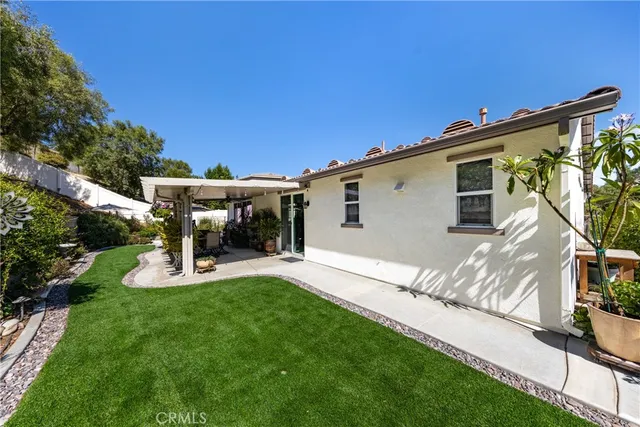 a view of a backyard with plants and a patio