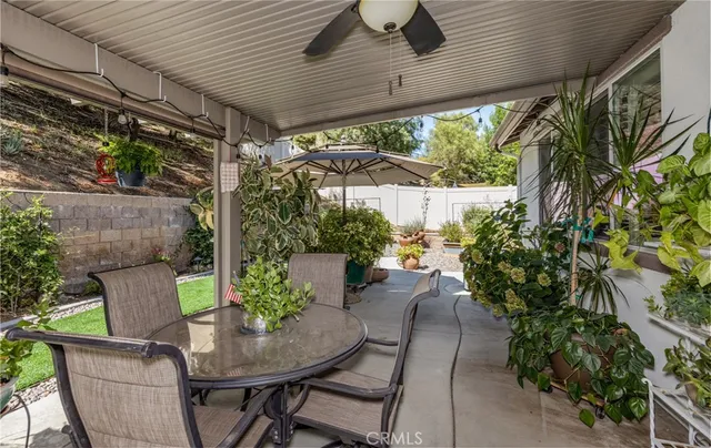a view of a patio with table and chairs potted plants with wooden floor