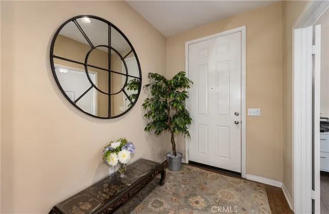 wooden floor with a potted plant and a window