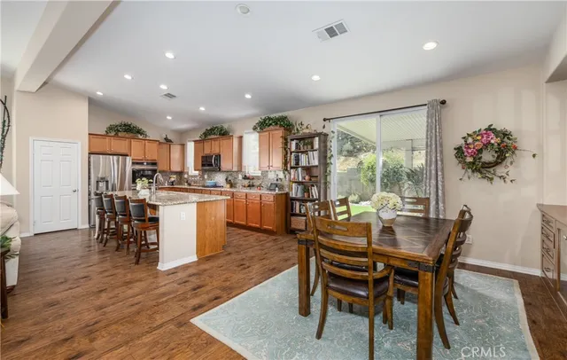 a dining room with furniture and wooden floor