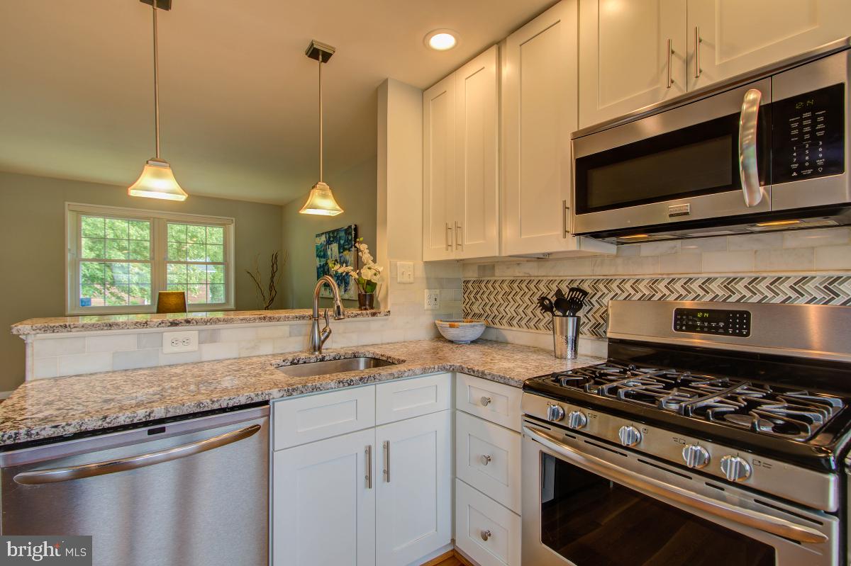 11206 Rock Road Rockville, MD 20852 - Photo 13 of 37 Granite counters. Glass tile backsplash.
