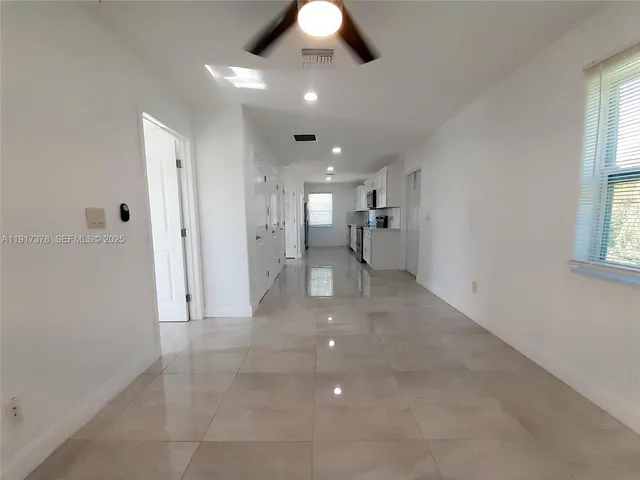 a view of a kitchen and a chandelier fan