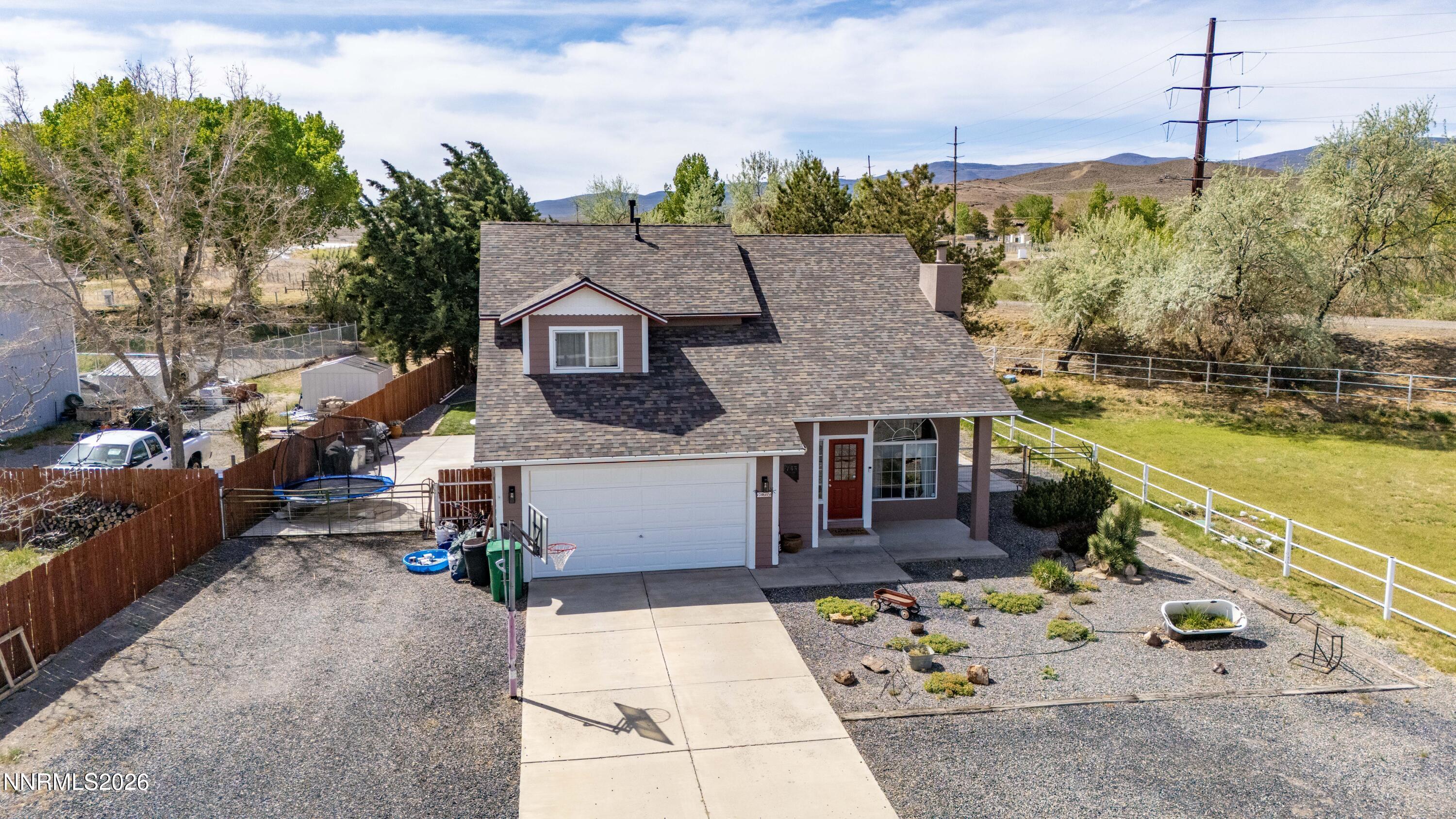 765 Stock Lane Fernley, NV 89408 - Photo 1 of 34 a front view of a house with a yard