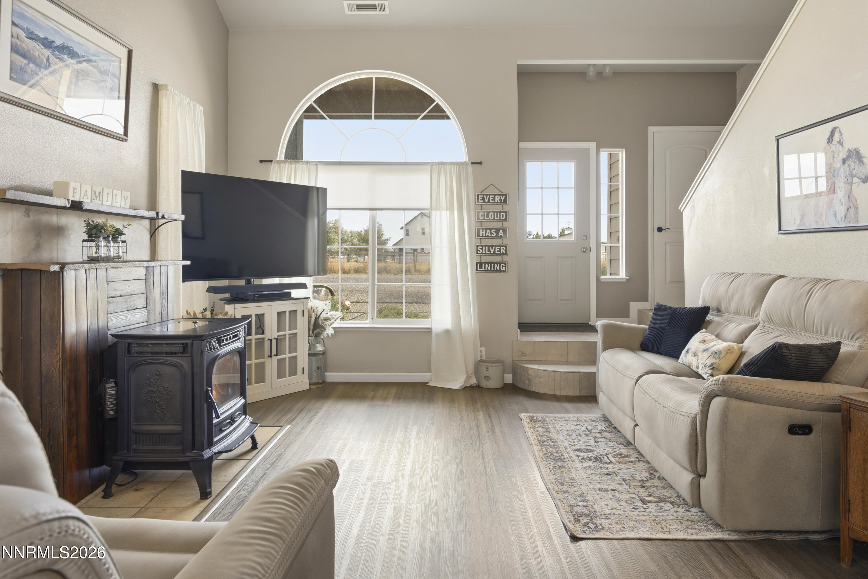 765 Stock Lane Fernley, NV 89408 - Photo 14 of 34 a living room with furniture a flat screen tv and a fireplace