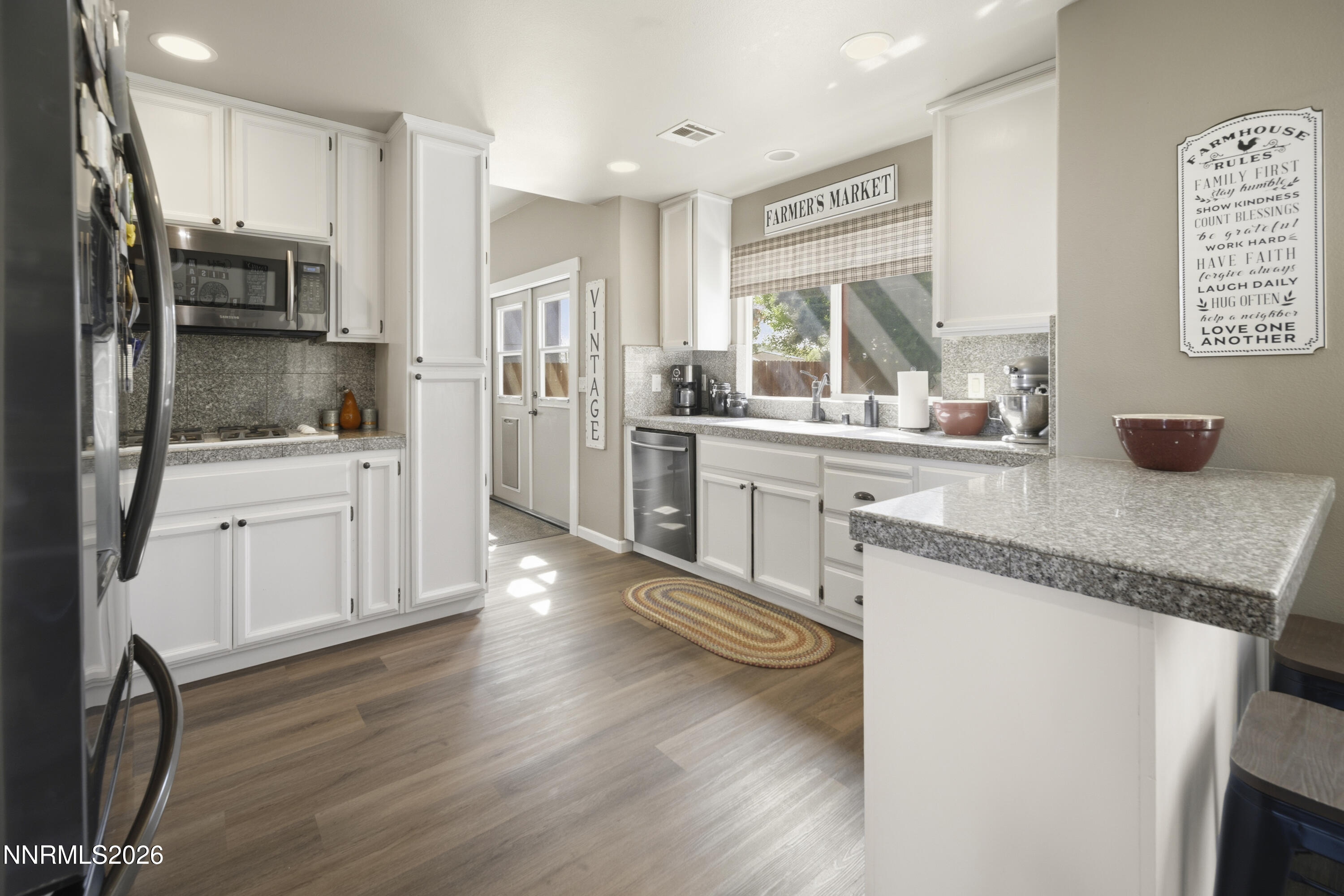 765 Stock Lane Fernley, NV 89408 - Photo 16 of 34 a kitchen with stainless steel appliances granite countertop a refrigerator and a stove top oven