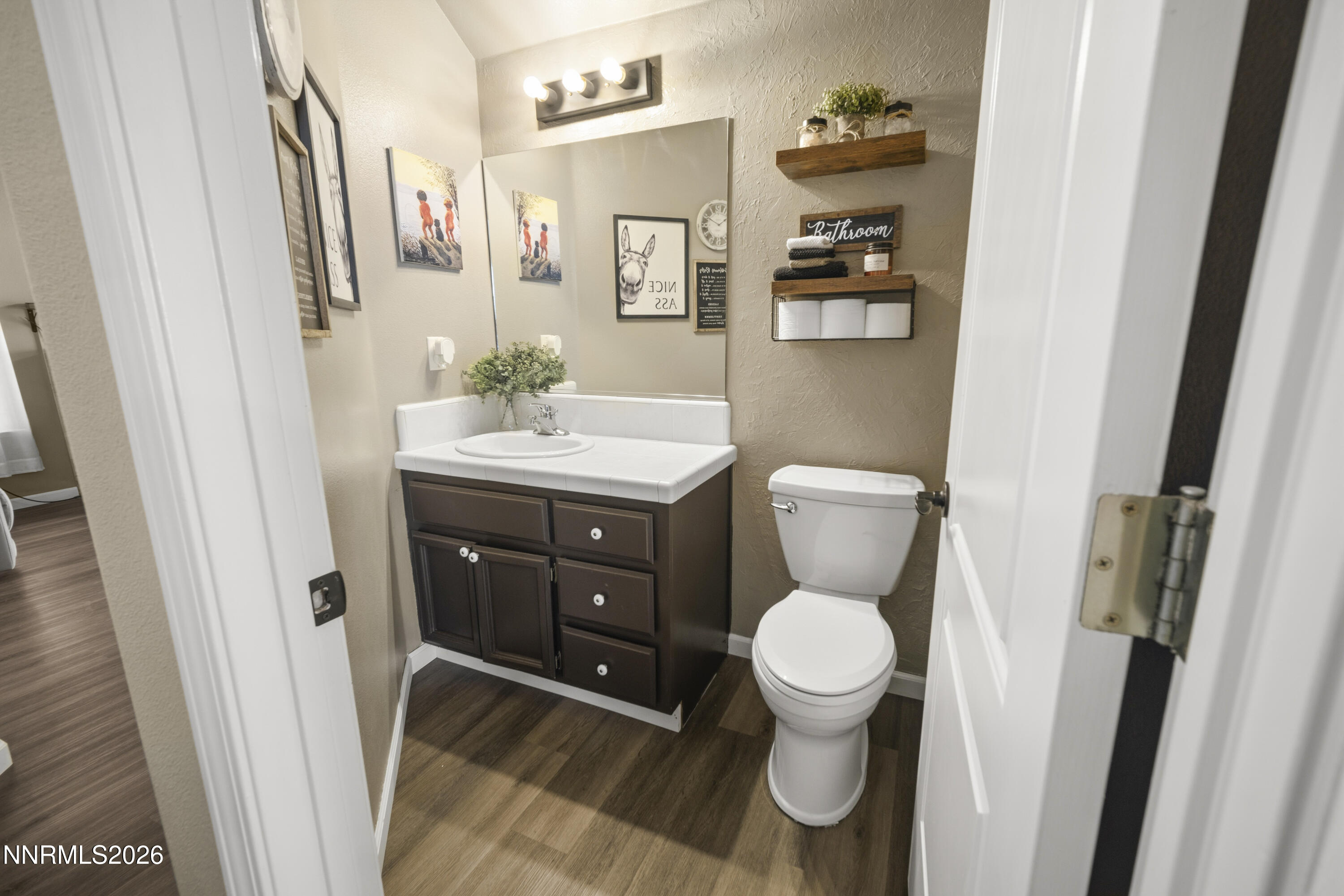 765 Stock Lane Fernley, NV 89408 - Photo 19 of 34 a bathroom with a toilet a sink and mirror