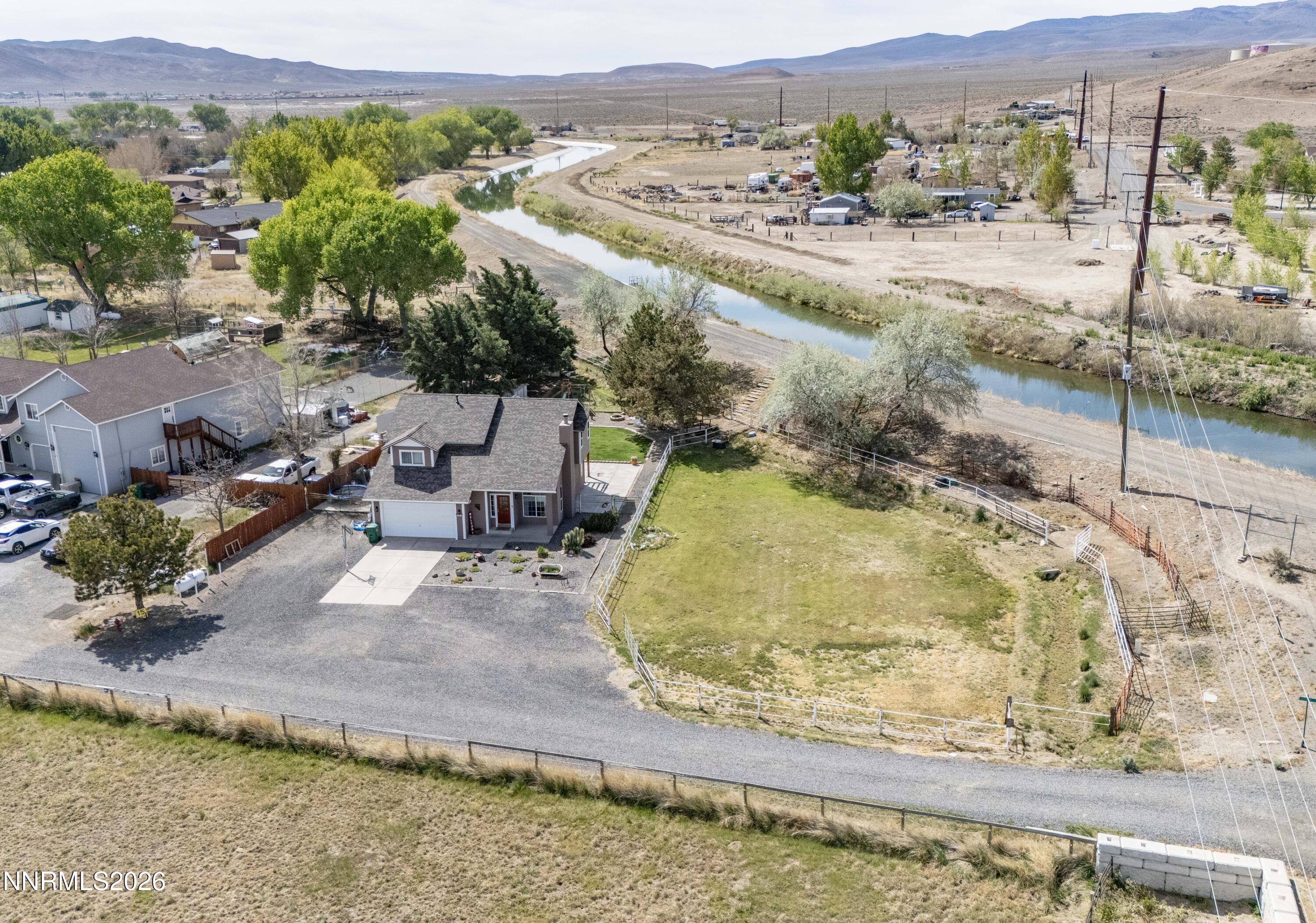 765 Stock Lane Fernley, NV 89408 - Photo 3 of 34 a view of a swimming pool with a yard and mountain view